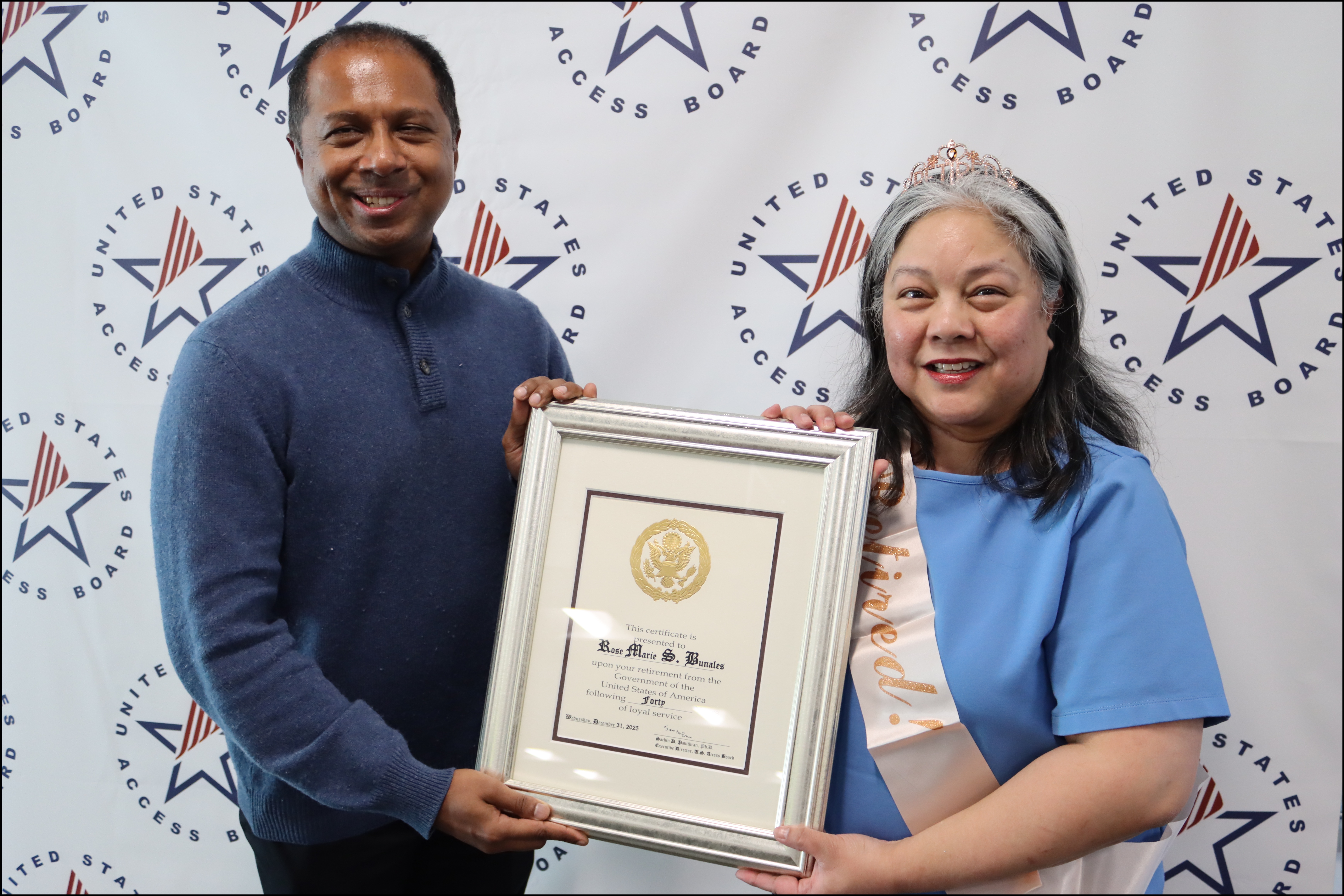 Rose Marie receives a retirement plaque from Executive Director Sachin Pavithran.